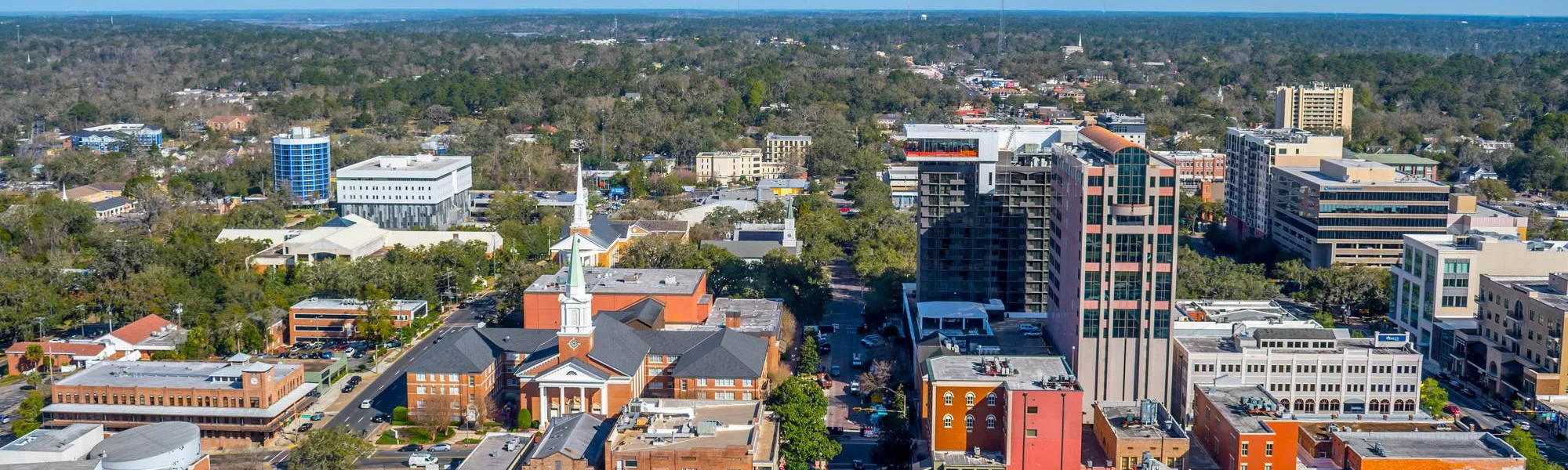 Aerial view of downtown Tallahassee with historic brick buildings, church steeples and office towers